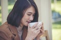 Close up Woman hand holding black coffee cup in green garden cafe. Hands of businesswoman love drinking hot coffee. business women Royalty Free Stock Photo