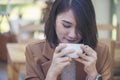 Close up Woman hand holding black coffee cup in green garden cafe. Hands of businesswoman love drinking hot coffee. business women Royalty Free Stock Photo