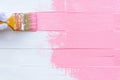 Close up woman hand holding brush painting pink color Royalty Free Stock Photo