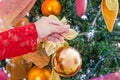 Close up of woman hand holding a christmas ball decorating a christmas tree, merry christmast and happy new year concept Royalty Free Stock Photo