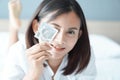 Close up woman hand holding condom with happy face lying on white bed, selective focus Royalty Free Stock Photo