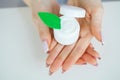 Close-up of a woman hand holding a container of moisturizer cream Royalty Free Stock Photo