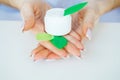 Close-up of a woman hand holding a container of moisturizer cream Royalty Free Stock Photo