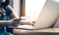 Close up woman hand holding credit card and typing keyboard laptop about shopping online concept Royalty Free Stock Photo