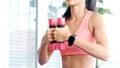 Close up of woman hand holding dumbbell for exercise at home, Female lifting sport equipment for weight training, People wellness
