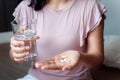 Close-Up Woman Hand is Holding Glass of Water While Taking Pills, Healthcare and Medicine Concept Royalty Free Stock Photo