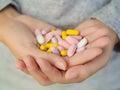 Close-up woman hand holding a lot of different pills. Royalty Free Stock Photo