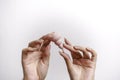 Close up of woman hand holding menstrual cup over white background. Women health concept, zero waste alternatives