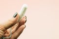 Close up of woman hand holding menstruation cotton tampon Royalty Free Stock Photo