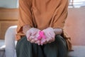 Close-up woman hand holding pink ribbon symbol. Breast cancer awareness and october pink day, world cancer day, national Royalty Free Stock Photo