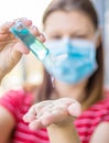 Close Up of Woman Hand Holding Sanitizer Alcohol Gel Dispenser Against 2019-nCoV Royalty Free Stock Photo