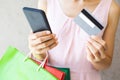 Close up of woman hand holding shopping bags ,smartphone and credit card Royalty Free Stock Photo