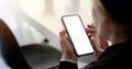 Close-up of a woman hand holding a smartphone white screen is blank the background is blurred.Mockup Royalty Free Stock Photo