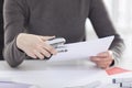 Close up of woman hand holding stapler Royalty Free Stock Photo