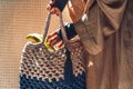 Close up of woman hand holding stylish bag at tropical background Royalty Free Stock Photo