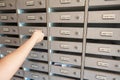 Close-Up Woman Hand Insert a Key to Unlock Mailbox Locker in Apartment, Interior Letterbox Cabinet in Condominium Royalty Free Stock Photo