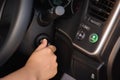 Close up of woman hand inserting a key to starting car engine Royalty Free Stock Photo