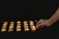 Close up of woman hand lighting candles in the dark night Royalty Free Stock Photo