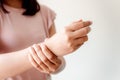 Close-Up of Woman Hand is Massaging Her Wrist Pain From Homework. Muscle Illness and Office Syndrome Concept. Healthcare and Royalty Free Stock Photo