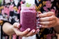 Close up woman hand with nails fashion color holding iced cold mixed berry smoothie Royalty Free Stock Photo