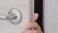 close up woman hand opening door in bedroom