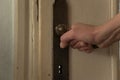 Close up of woman hand opens the old door Royalty Free Stock Photo