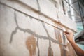 Close up of woman hand plastering old building wall Royalty Free Stock Photo