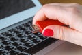 Close up of a woman hand plugging a pendrive on a laptop Royalty Free Stock Photo