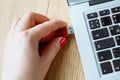 Close up of a woman hand plugging a pendrive on a laptop Royalty Free Stock Photo