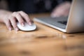 Close up of woman hand searching and click mouse using laptop Royalty Free Stock Photo