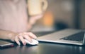 Close up of woman hand searching and click mouse using laptop Royalty Free Stock Photo