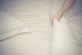 Close up woman hand set up white bed sheet in hotel room Royalty Free Stock Photo