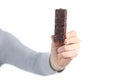 Woman hand showing chocolate snack isolated on white