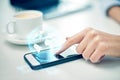 Close up of woman hand with smartphone and globe