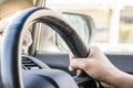 Close-up of a woman hand on a steering wheel Royalty Free Stock Photo