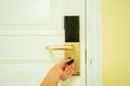 Woman hand twist doorknob to lock the room in luxury hotel