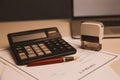 Close up woman hand using calculator and writing make note with calculate about cost at home office Royalty Free Stock Photo