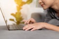 Close up woman hand using laptop on sofa Royalty Free Stock Photo