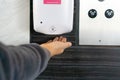 Close up of woman hand using sanitizer gel dispenser to disinfecting, cleaning, washing hands . Health care, new normal lifestyle