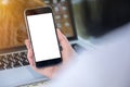 Close up Woman hand Using a Smart Phone with blank screen at cafe coffee shop. Royalty Free Stock Photo