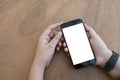 Close up Woman hand Using a Smart Phone with blank screen at cafe coffee shop. Royalty Free Stock Photo