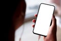 Close up Woman hand Using a Smart Phone with earbuds at cafe coffee shop. Royalty Free Stock Photo