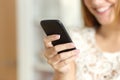 Close up of a woman hand using a smart phone at home