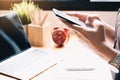 Close up Woman hand Using a Smart Phone with use laptop at home office Royalty Free Stock Photo