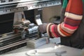 close up woman hand working in a modern factory and preparing materia for a CNC machine. Royalty Free Stock Photo