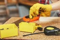 Beautiful caucasian young woman working in carpentry workshop at table place Royalty Free Stock Photo