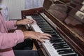 Close up of woman hands classic piano playing. Teen Woman relaxing and playing the piano in the living room Royalty Free Stock Photo