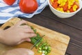 Close Up of woman hands cooking vegetable salad in kitchen on the wooden table. Healthy meal, and vegetarian food Royalty Free Stock Photo