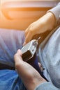 Close up of woman hands fasten belts while sitting on airplane s