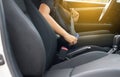 Close up of woman hands fastening or putting seat belt in car,Transportation and vehicle concept Royalty Free Stock Photo
